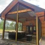 Gable-style patio with hot tub enclosed by Mountain View Screens for insect protection.
