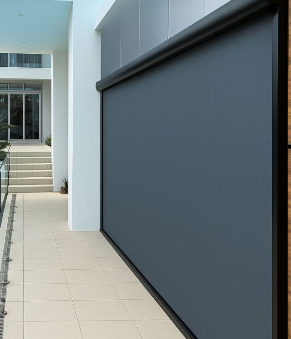 Modern patio with motorized screen fully lowered for shade and privacy.